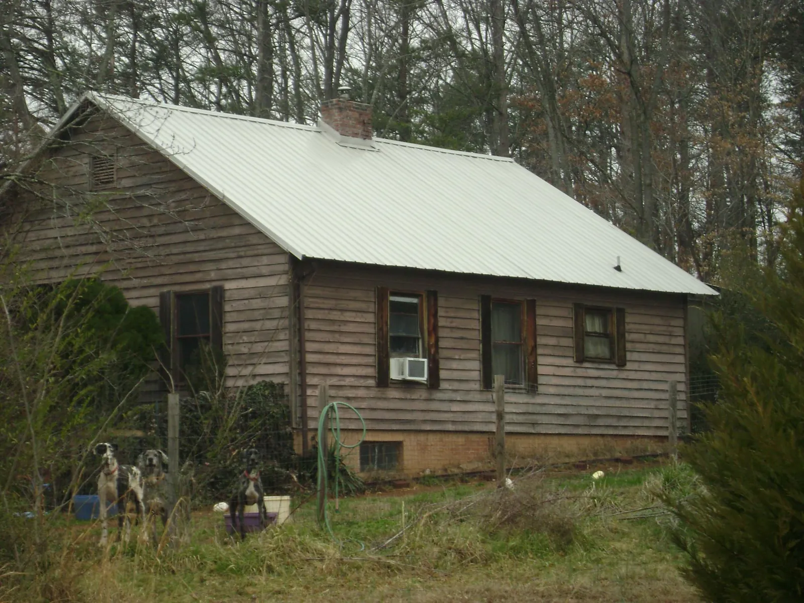 White metal roof on an old wood sided farmhouse, from a Metal Roof Installation job in Juniata